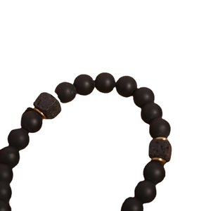 Men's lava rock and black onyx beaded bracelet with matte finish and gold accents