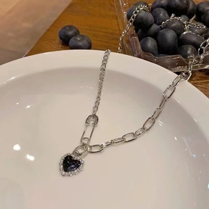 Silver safety pin necklace with black heart pendant and sparkling zircon accents