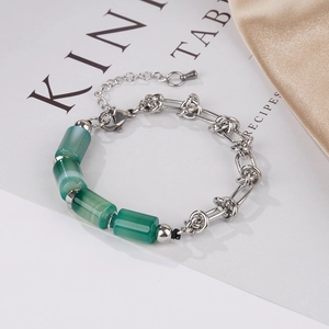 Detail of bamboo-style green jade beads joined with a twisted silver chain bracelet