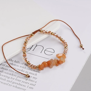 Detail view of Bohemian amber stone beads and gold crystals on adjustable woven bracelet