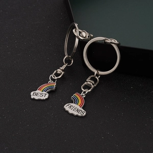 Dettaglio dei portachiavi Best Friends con arcobaleno e nuvole bianche su fondo grigio