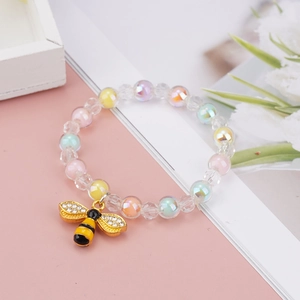 Close-up of colorful iridescent beaded bracelet for girls with a gold honeybee pendant