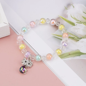 Detailed macro view of children's colorful beaded bracelet with a diamond cat charm pendant