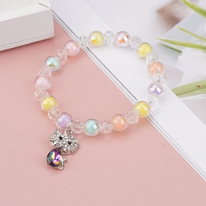 Detail of colorful beaded bracelet for girls with a sparkling crystal cat pendant