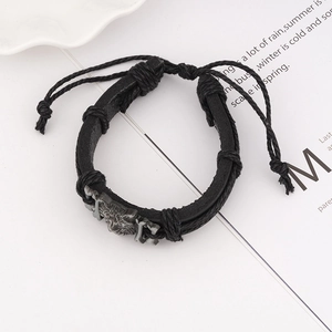 Retro woven leather bracelet for men featuring a metallic wolf head with adjustable cord