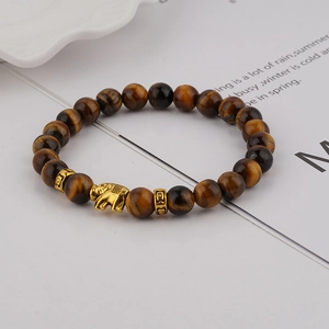 8mm Tiger Eye stone bead bracelet with a golden elephant charm on white background