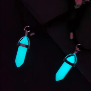 Luminous hexagonal pillar pendant necklaces glowing in neon blue with black cord straps
