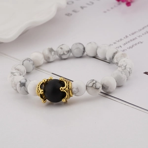 Detailed shot of tiger eye stone beads bracelet featuring vintage golden crown accents