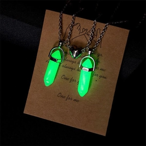 Close-up of magnetic heart connector on luminous hexagonal crystal couple necklaces