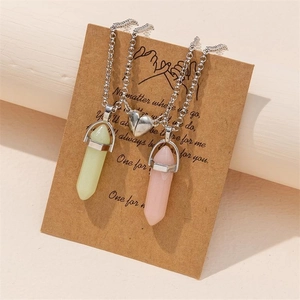 Close-up of heart magnetic clasp connecting pink and green hexagonal stone necklaces