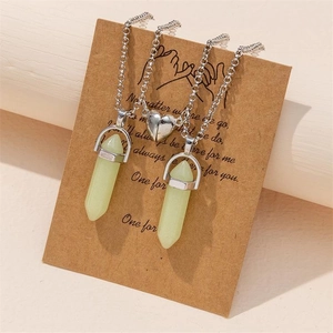 Detailed view of luminous hexagonal crystal necklaces with magnetic heart on a gift card