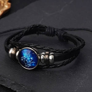 Braided leather zodiac bracelet featuring a glowing Sagittarius charm and metal beads