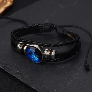 Detail of Libra zodiac leather bracelet with glowing glass charm and braided cords