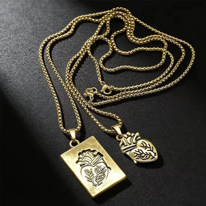 Detail of interlocking anatomical heart pendants on gold plated couple necklaces