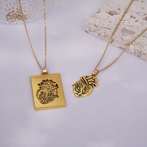 Detailed view of vintage gold anatomical heart pendants with textured metallic finish
