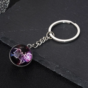 Detail view of Sagittarius constellation keychain with glass dome and nebula art