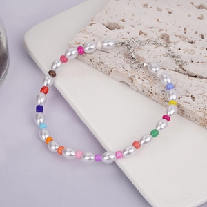 Colorful beaded bracelet with oval pearls and lobster clasp on stone background