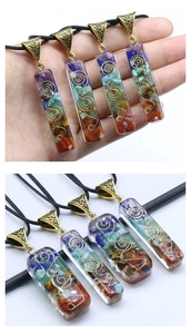 Macro detail of Orgone energy healing pendant with colorful chakra stones and resin