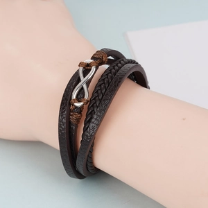 Détail du bracelet multicouche en cuir marron avec symbole infini et tressage fait main