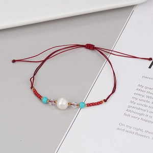 Handmade red braided cord bracelet with freshwater pearl and adjustable slide knot closure