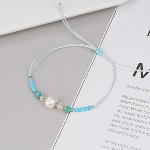 Handmade woven light blue bracelet with freshwater pearl and adjustable cord for women