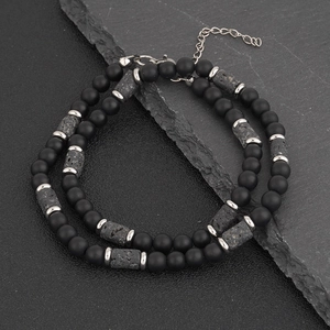 Detail of matte black beads and lava stone necklace with silver spacers and adjustable chain
