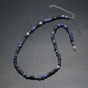 Detail view of tiger eye beads and lava stone necklace with adjustable steel clasp