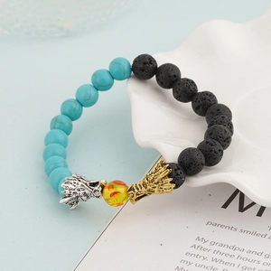 Detail of beaded dragon bracelet featuring lava stone and turquoise with metal accents