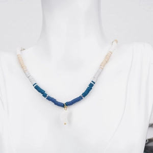 Bohemian colorful heishi bead necklace with white moon pendant on a display mannequin