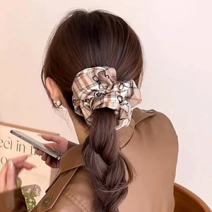 French vintage plaid scrunchie with butterfly bow design on model ponytail