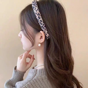 Classic leopard print wide headband for women styled with large pearl drop earrings