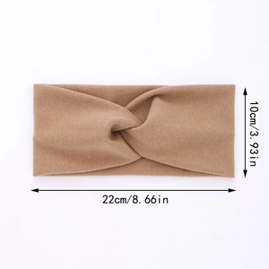 Close-up of khaki knitted headband with central twist showing 22cm length and 10cm width