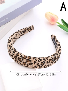 Close-up of leopard print fabric headband with handmade label and size dimensions