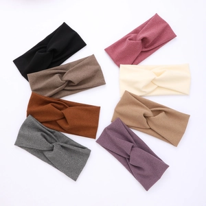 Eight colors of women's knot headbands made of soft elastic knit fabric on white background