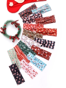 Multiple Christmas knot headbands featuring festive patterns like reindeer and snowflakes