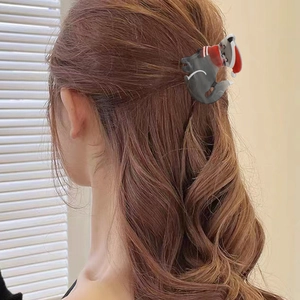Graziosa clip per capelli a gatto in acrilico con cappello di Natale sulla nuca