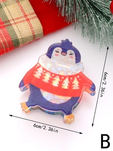 Dettaglio di un fermaglio per capelli a pinguino da 6cm con motivo a maglione natalizio
