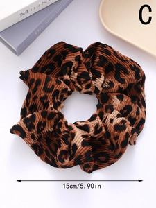 Detail showing 5.9-inch leopard print pleated scrunchie with soft fabric texture