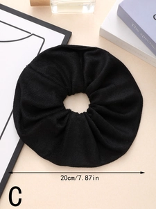 Detail view of large 20cm black absorbent towel scrunchie showing plush fabric texture