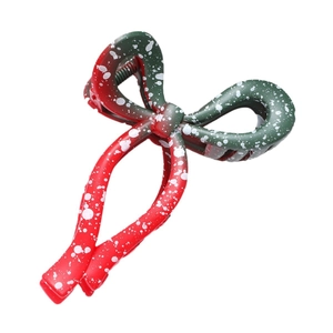 Christmas bow hair claw clip with red green colors and snowflake pattern for festive hair styling