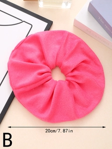 Detail shot of oversized bright pink absorbent hair scrunchie with 20cm diameter mark
