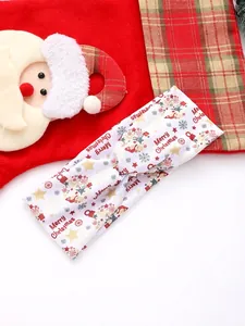 Detail of Christmas headband featuring Merry Christmas print and soft twisted knot design