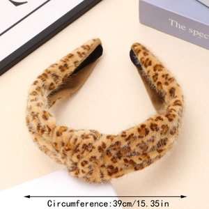 Close-up of leopard print plush headband with a soft faux fur texture and knotted detail
