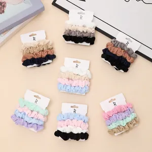 4-piece set of textured autumn winter scrunchies in assorted soft colors on display card