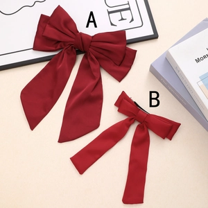 Elegant red satin bow hair clips in large and medium sizes for festive styling
