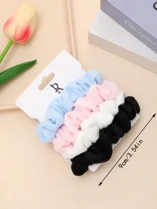 Detailed view of 4-pack plush towel scrunchies in four colors on a display card