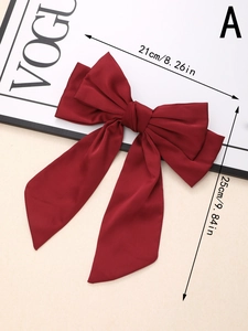 Detail view of large burgundy silk satin bow hair clip with ribbons and size measurements