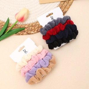 Set of 4 plush high ponytail hair ties in assorted colors on elegant display cards