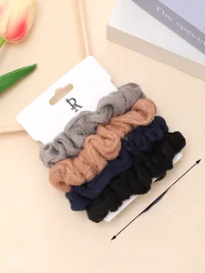 Detailed view of 4-piece plush scrunchie set in gray, pink, navy, and black colors