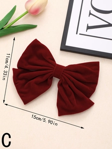 Detail showing dimensions of 15cm x 11cm for this large red velvet bow hair clip